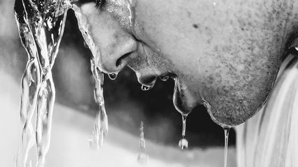 Water running over a face in black and white