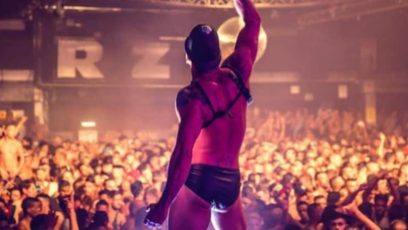 A performer above a crowd in a club